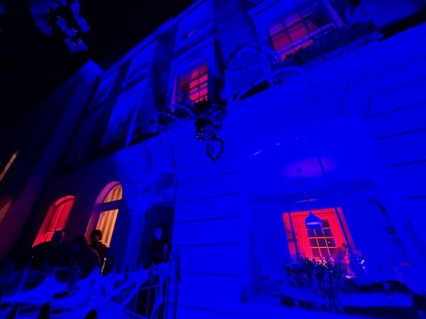 dark and spooky image of a London home decorated for halloween with creepy lighting and giant spiders