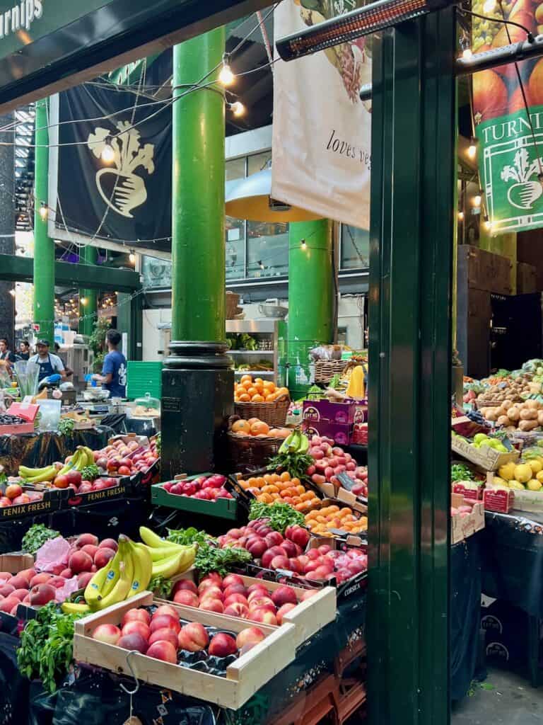 Image of the produce stalls at ancient Borough Market. You can take home many shelf-stable foods that make great gifts from london. 