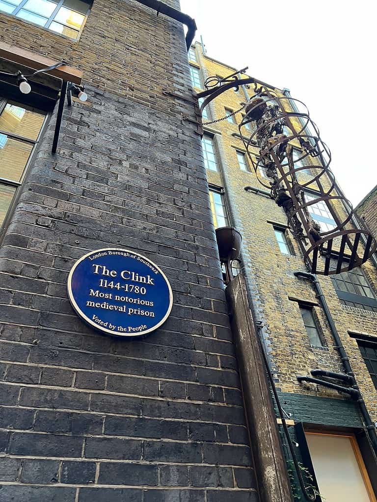 Exterior of the clink prison museum with sign reading: "the clink 1144-1780 Most notorious medieval prison"